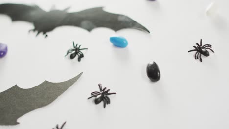 Close-up-of-multiple-halloween-toys-and-candies-on-white-background