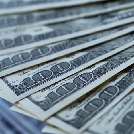 dollar background with money rotation. one hundred dollar bills spinning around. cash of paper money. close-up.