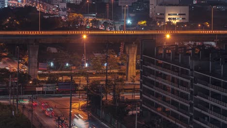 bangkok traffic at night viewed from maple hotel. zoom in on illuminated streets, timelapse