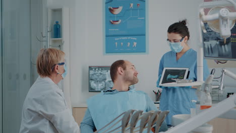 dentistry team explaining radiography to sick patient