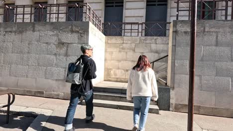 a couple ascends stairs in a paris street