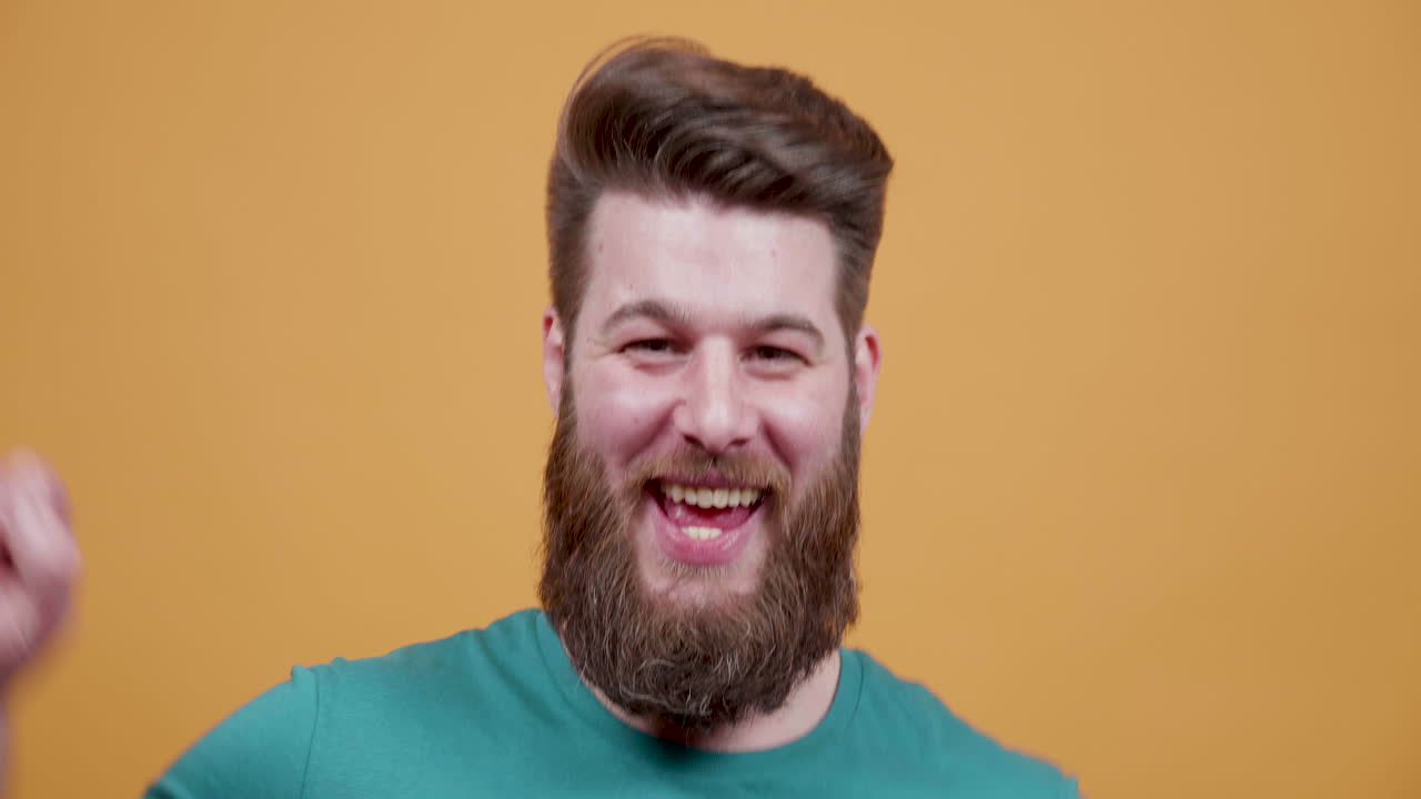 Happy bearded man smiling at the camera