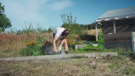 A-Man-is-Using-a-Tool-to-Cut-the-Timber-Meant-for-Constructing-a-Greenhouse-in-Indre-Fosen,-Trondelag-County,-Norway---Static-Shot