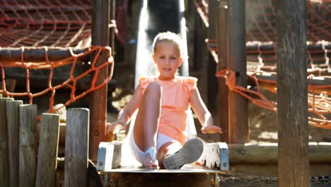 schoolgirl sliding on slide in school playground