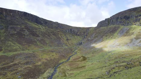 drone establishing shot of the mahon valley and mahon falls with trail to the falls spring morning