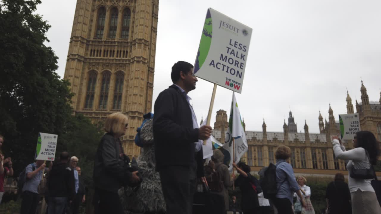 Climate change protestors lobby outside Parliament and along the Thames with placards