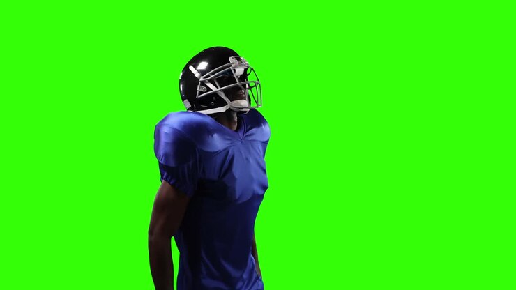 African American football player on green screen background.
