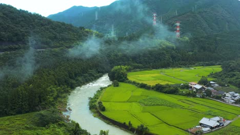 landscape of shikoku japan, aerial tilt of rural town and farms