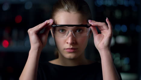 Portrait-of-serious-girl-wearing-glasses-on-night-background.Model-in-glasses-.