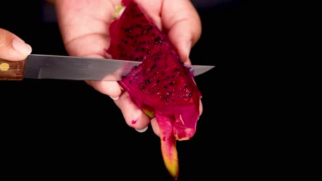 hand peeling dragon fruit using a knife