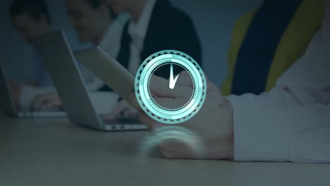 animation of clock over business people using tablets and laptops