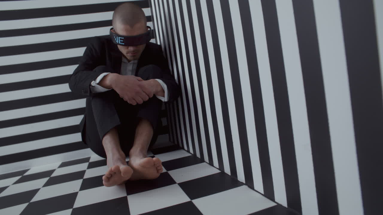 Man in VR Glasses, Depressed in Geometric Optical Illusion Room