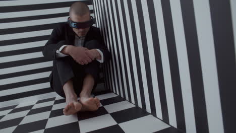 man in vr glasses, depressed in geometric optical illusion room