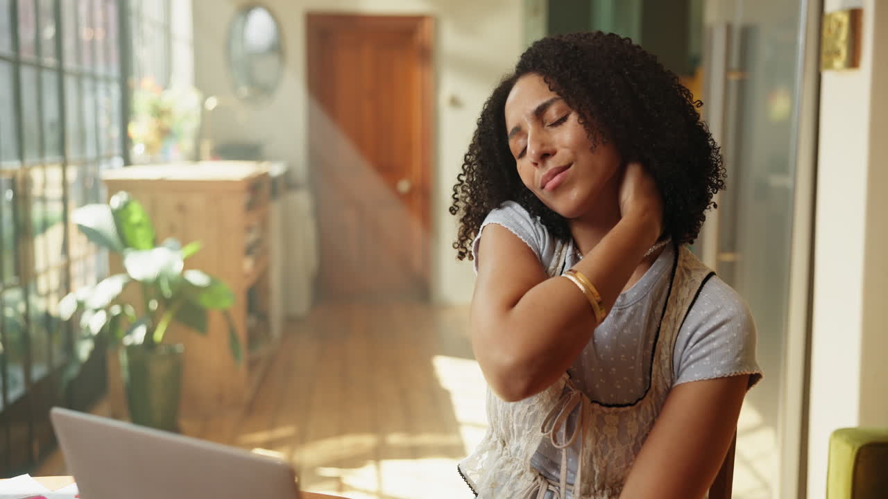 Young Woman Experiences Neck and Shoulder Pain While Working on Laptop