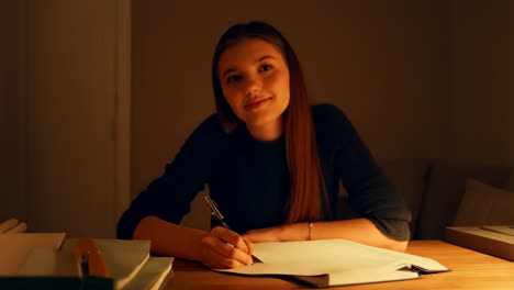 teenage girl studying at night