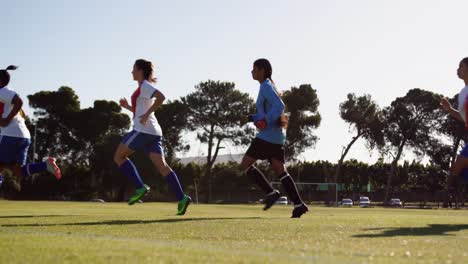 Female-soccer-team-running-lapse-on-soccer-field.-4k