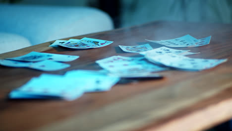 scattered playing cards on wooden table