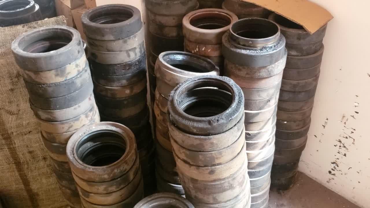 footage captures a storage space containing numerous sizable cylindrical items, likely railway train wheelset bearing