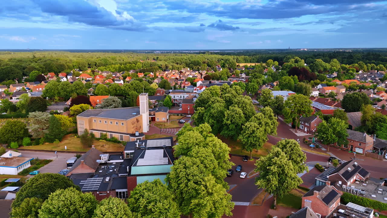 Dutch countryside with green fields and village houses aerial view. Aerial view of Dutch countryside with green fields and residential houses surrounded by nature