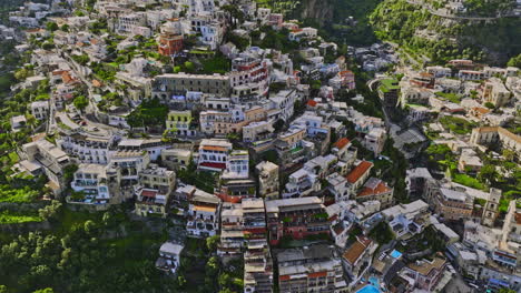 positano italy aerial v3 birds eye view, flyover coastal cliffside town capturing charming neighborhood, narrow streets and terraced buildings with colorful facade - shot with mavic 3 cine - may 2023