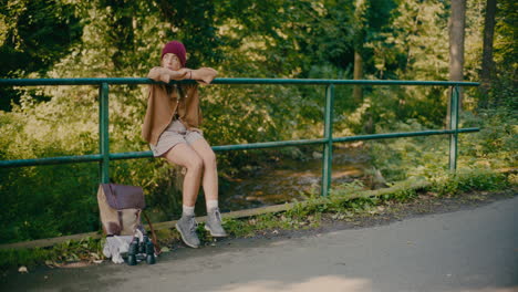 Tired-Woman-Sitting-On-Railing-In-Forest