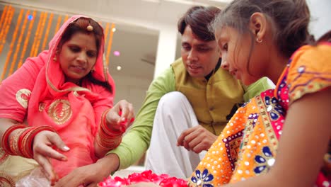 young parents with daughter celebrate decorate for diwali festival