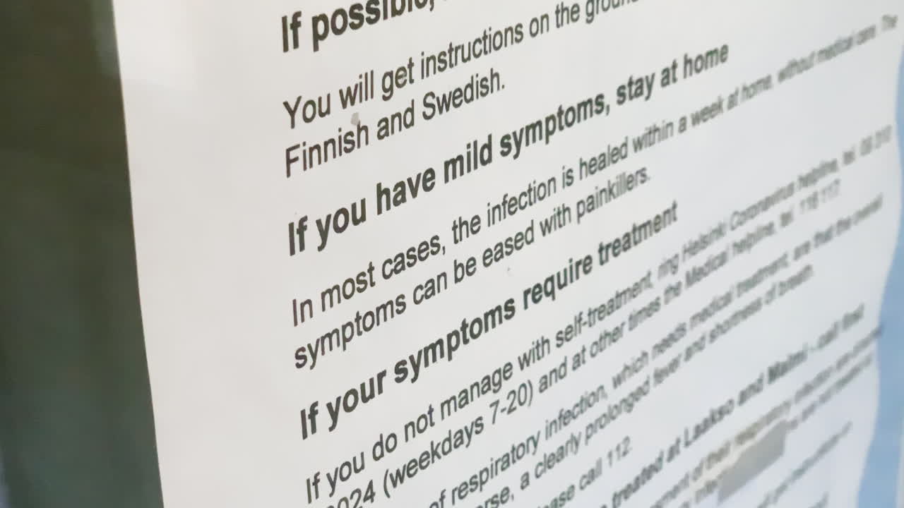 Coronavirus note on a information glass, at a healthcare station - COVID-19, stay at home, flatten the curve - handheld view