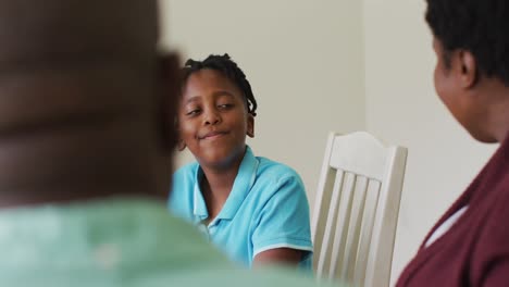 African-american-boy-eating-breakfast-together-with-his-family-at-home