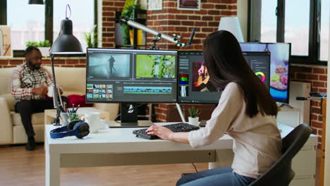 asian woman editing a music video in her living room studio