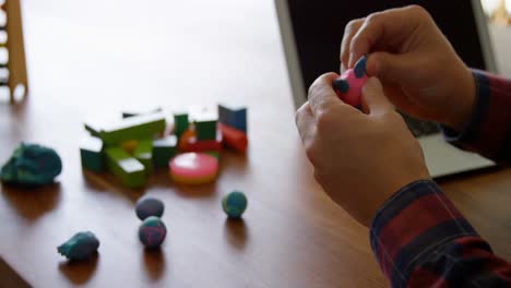 Father-and-daughter-playing-with-clay-in-living-room-4k