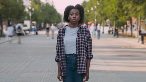 teenage girl in plaid shirt on city street