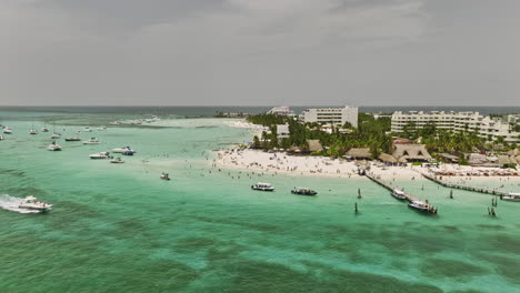 Isla-Mujeres-Mexico-Aerial-v16-low-flyover-beautiful-island-with-tourists-crowd,-Playa-Norte-with-white-sandy-beach-and-crystal-clear-turquoise-blue-sea-waters---Shot-with-Mavic-3-Cine---July-2022