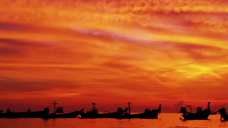 Aerial-shot-of-Koh-Tao-island,-Super-sunset-at-Sairee-Beach-with-many-boats-floating-Thailand