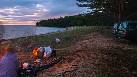dusk camping scene by the beach with translucent figures and cars