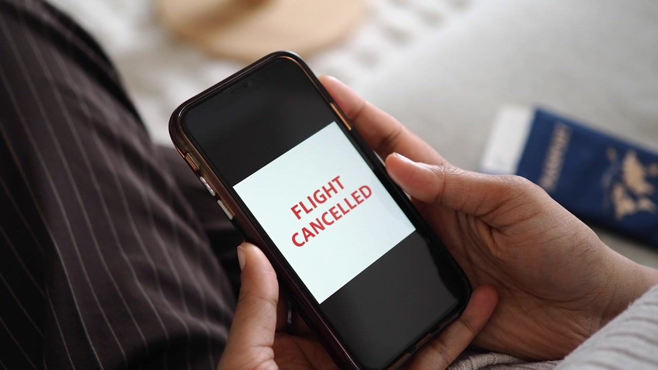 Person Checking Flight Cancellation Notification on Smartphone