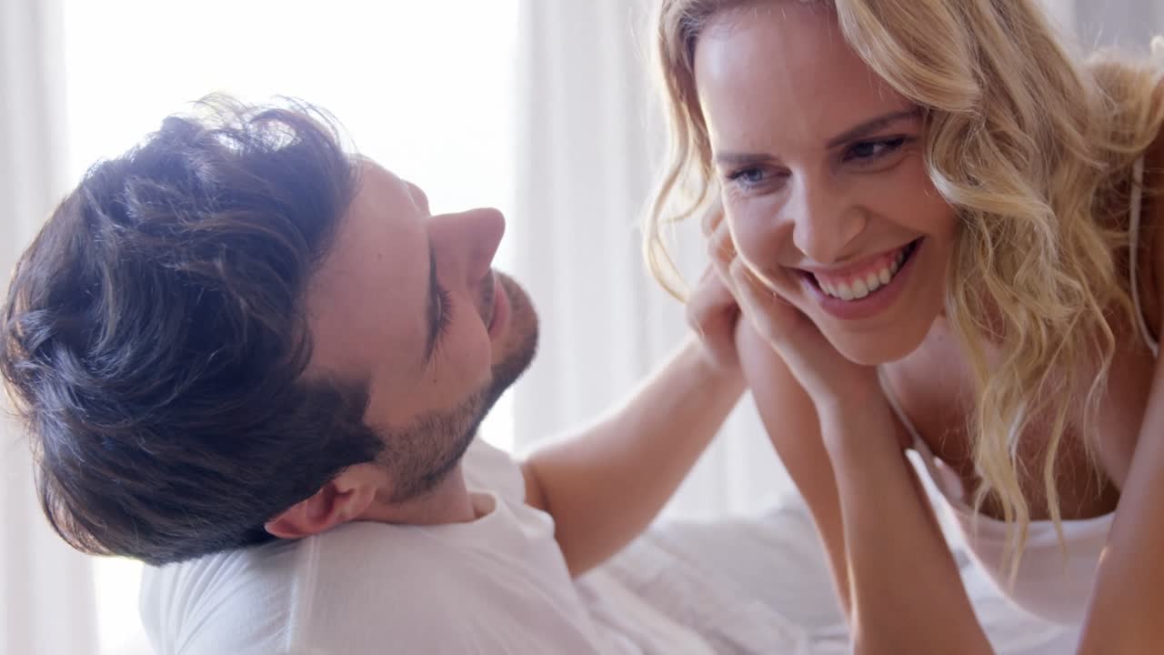 Couple embracing in bed