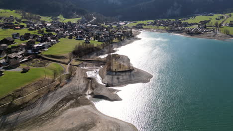 Aerial-Of-Lake-Lake-Lungern,-Inseli-Lugern-And-Lungern-Town,-Obwalden,-Switzerland