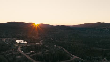 Sunset-Streaming-Over-Mountains-And-Forest-Near-Saint-Come,-Quebec,-Canada