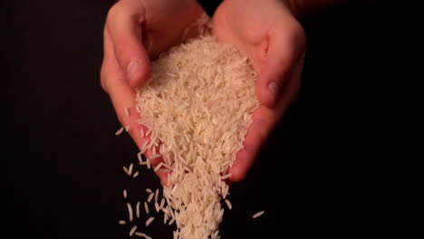 Woman-spilling-white-rice-from-her-hands