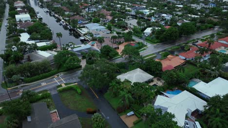 aerial view of a residential neighborhood with canals and palm trees