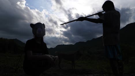 boy with gun hunting boy wearing animal mask
