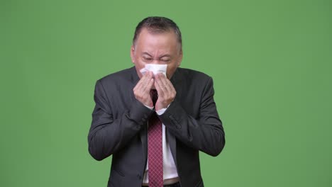 mature japanese businessman feeling sick
