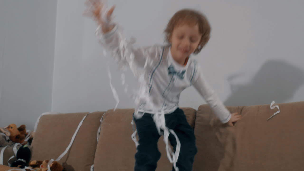 Little boy having good time at paper party