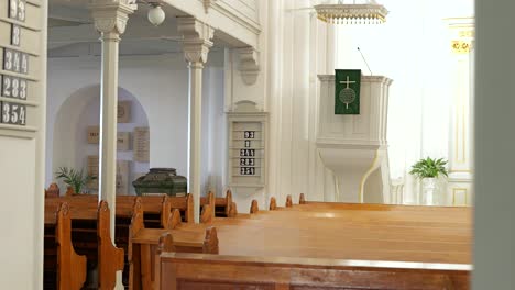 Pulpit,-hymn-board,-sanctuary-of-Lutheran-church,-slow-reveal-from-behind-wall