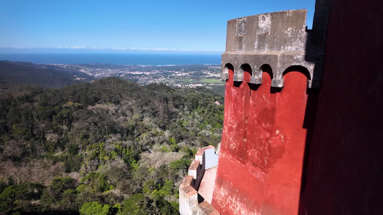 Slowmotion view of Pena Palace tower with ocean backdrop