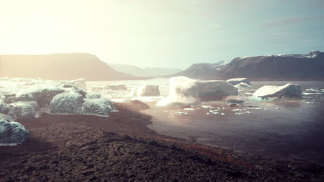 gigantic ice block structures on the black sand by the sea shore