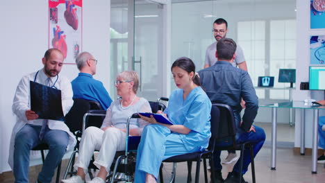 Doctor-discussing-diagnosis-with-disabled-senior-woman