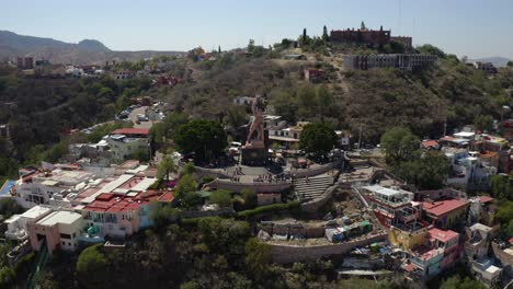 Aerial-drone-backward-moving-shot-of-residential-houses-along-the-hills-of-Tijuana,-Mexico,-filmed-in-early-morning-light