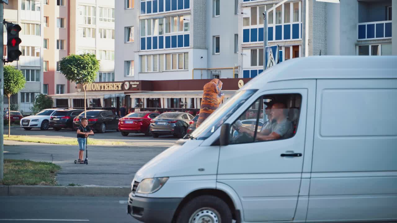 Inflatable animated doll. Big dinosaur doll walking in city