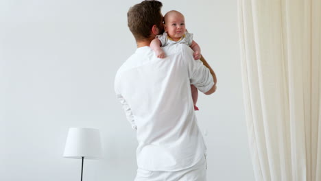 unrecognizable father caressing crying newborn baby son